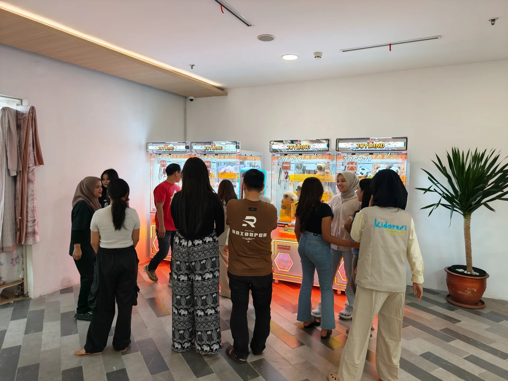 Guests gathering around a row of illuminated Joyland machines